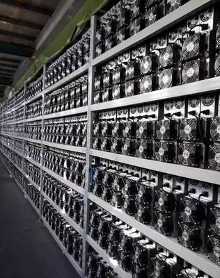 A large scale Bitcoin mining farm with rows of mining rigs